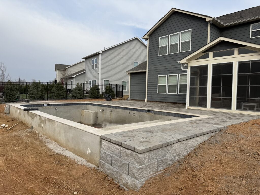 Finished paver patio with a block seat wall