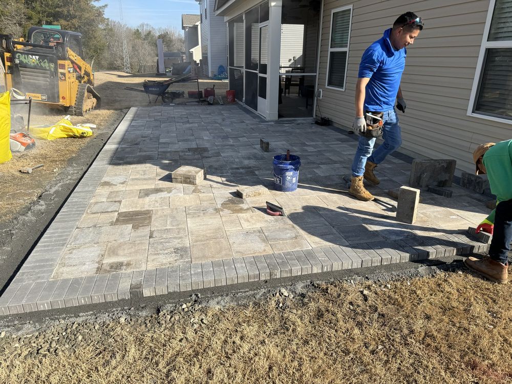 Crew installing a paver patio