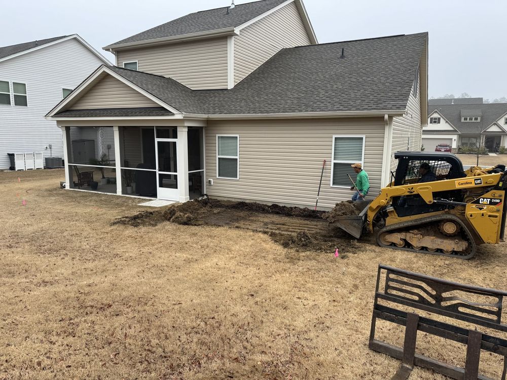 Grading a yard with a compact track loader